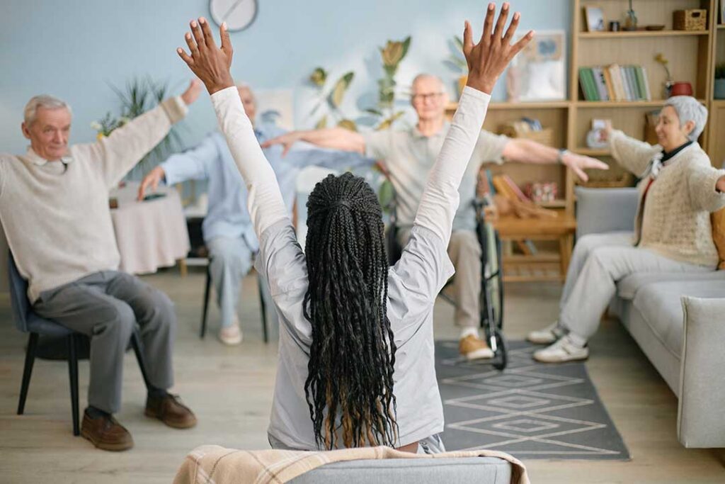 Older adult and family member review advance care documents at a kitchen table.